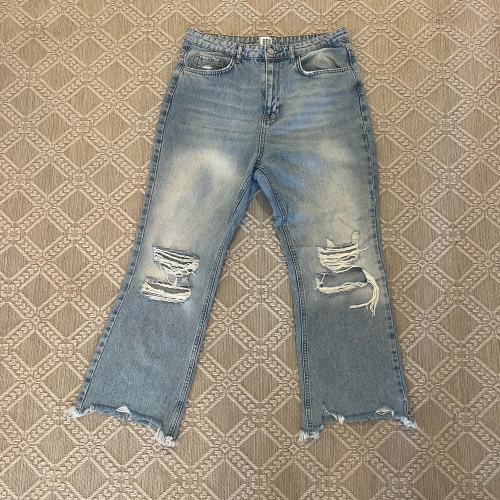 BDG distressed light-wash jeans with rips at knees and frayed hem